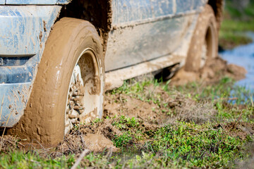 Car wheel stuck in mud, motorsport, mud tire testing. Off-road driving, car breakdown. Emergency evacuation. © Vera