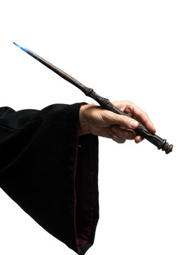 Rugged caucasian wizard's hand in a black velvet robe holding a glowing magic wand against a white background. Concept of arcane power and fantasy