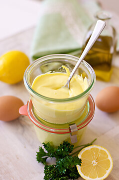 Fresh home-made mayonnaise in a pretty jar with base ingredients 