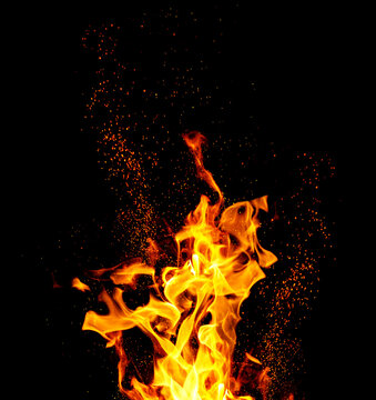 Bright flames and flying sparks on a black background.