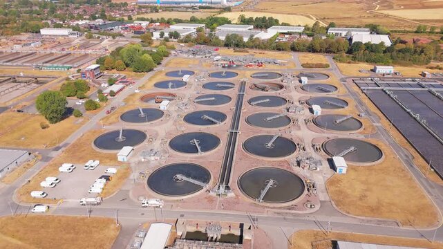 A drone orbit movement over clarification tanks at a large scale waste water facility in Minworth, UK