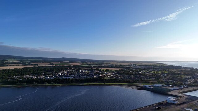 Wide angle aerial drone view of the coastal town of Invergordon along the Cromarty Firth, Ross and Cromarty, Scottish Highlands, Scotland, UK