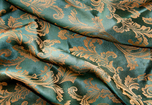 Detailed teal and gold damask fabric pattern with intricate woven textures ornamental jacquard background intricate