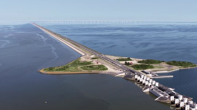 Aerial view of the afsluitdijk dam in the netherlands with a highway and wind turbines