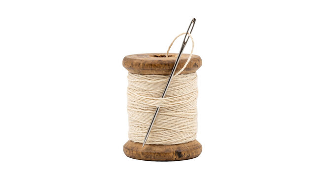 Vintage wooden spool of thread with a needle inserted, ready for sewing