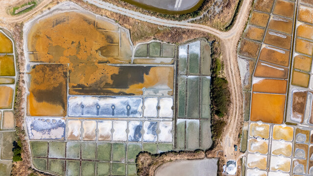 Aerial drone top-down view of Guerande salt marshes geometric pools and reflection, Loire-Atlantique, France