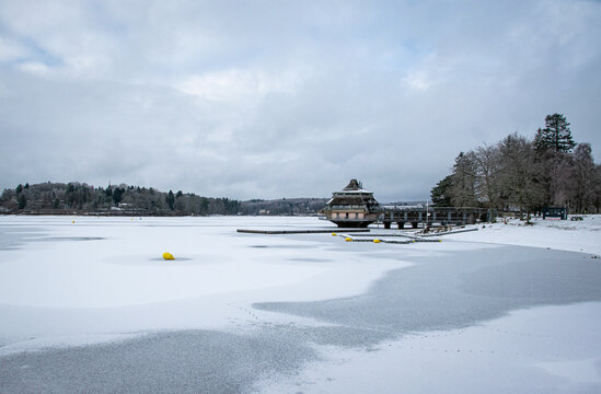 Frozen Settons lake and snow-covered restaurant on water in Morvan regional park, Burgundy, France