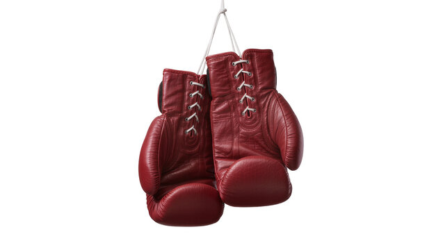 Pair of red leather boxing gloves with white laces, hanging isolated on transparent background