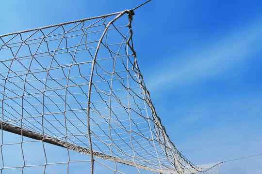  Close-up textured soccer net on soccer goal isolated on free sky background.