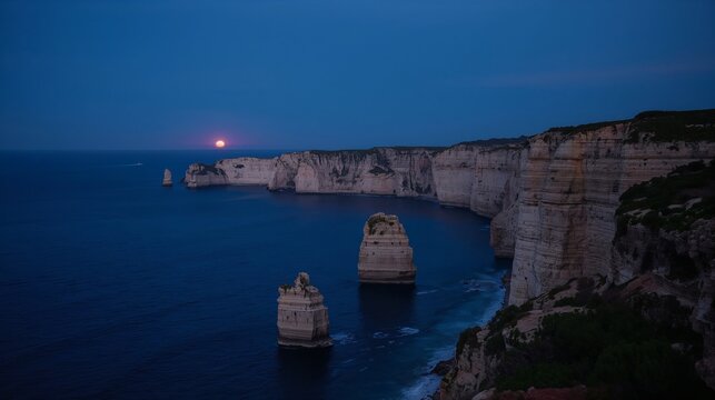 Rocky Mediterranean cliffs illuminated by the last light after sunset