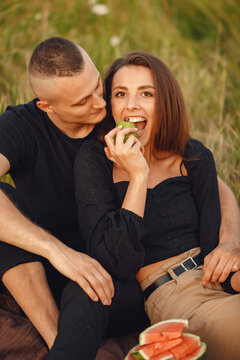 Beautiful couple spend time on a summer field
