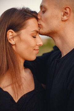 Beautiful couple spend time on a summer field