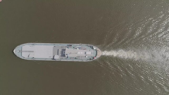 Vertical drone shot of barge and boat