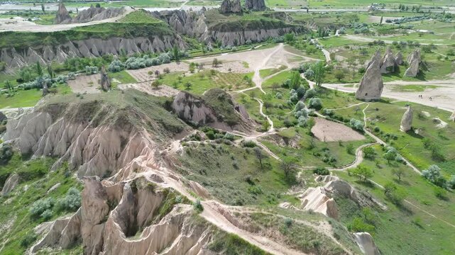 Aerial drone footage flying forward and descending low over the foothills of Red Valley in Cappadocia, Turkey.