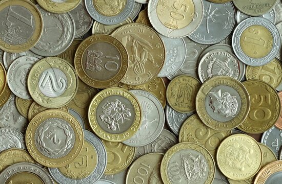 Big pile of coins from different money currencies. Treasure and numismatics concept