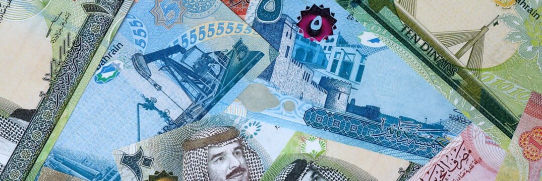 Bahraini dinar money bills in pile on table. Bahrain BHD currency cash close up