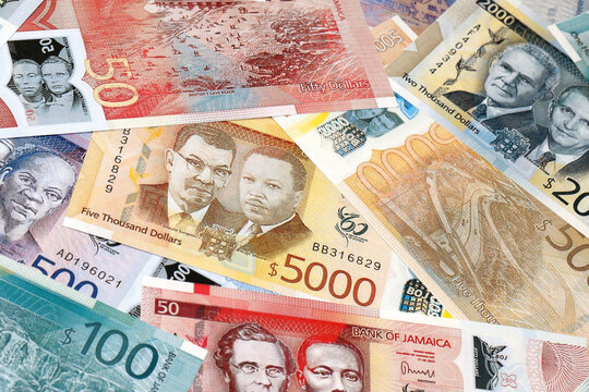 Jamaican dollar money bills in pile on table. Jamaica JMD currency cash close up