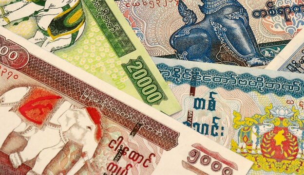 Myanmar kyat money bills in pile on table. Myanmar MMK currency cash close up