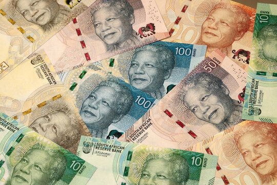 South African rand money bills in pile on table. South Africa ZAR currency cash close up