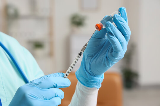 Female doctor with hormone injection in clinic, closeup