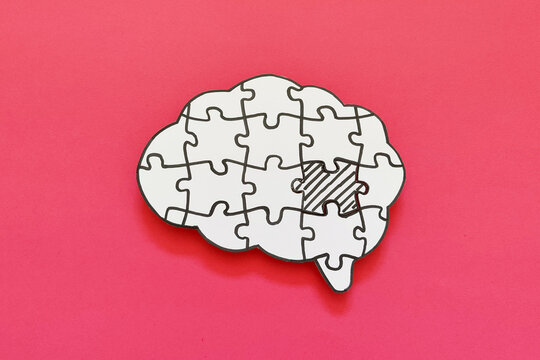 Mental health and problems with memory. Brain shaped jigsaw puzzle with missing piece.