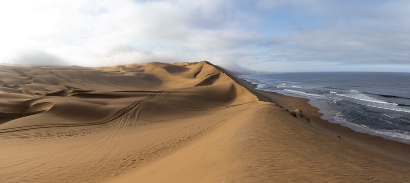 Sand dunes and sea in morning light, Atlantic coast and Namib desert, impressive desert landscape, Sandwich Harbour, Namib Naukluft Park, Namibia