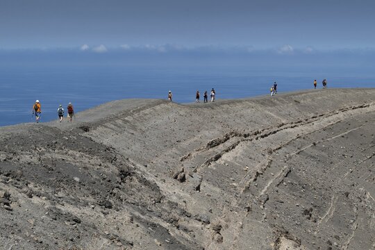 Visitors walk along the crater rim, Vulcano, Aeolian or Aeolian Islands, Sicily, Southern Italy, Italy
