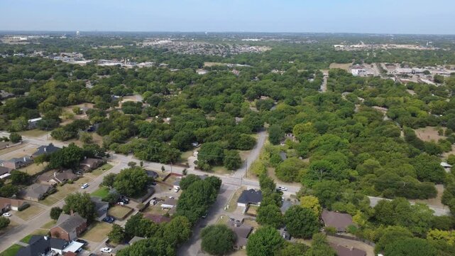 Sprawling semi rural acreage borders residential subdivisions along Pleasant Run Road. Heavy green foliage buffers detached outbuildings, expansive grassy homestead lots, DeSoto, Texas