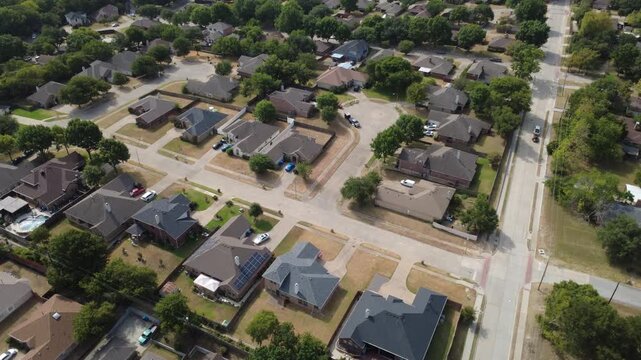 Shaded suburban avenues intersect residential acreage properties near Polk Street. Detached metal carports, lush oak tree canopies border quiet neighborhood dwellings, DeSoto, Texas