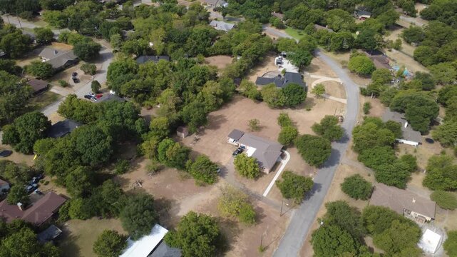 Broad homestead acreage parcels spread across open land near Pleasant Run Road. Extended concrete driveways, dark architectural roofs border expansive green turf lawns, DeSoto, Texas