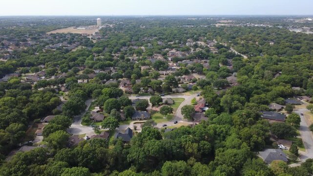 Paved cul de sac streets branch through quiet enclaves near Hampton Road. Well maintained turf lawns, dark architectural shingles highlight established residential blocks, DeSoto, TX