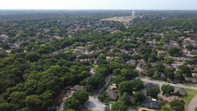 Sprawling residential subdivisions spread across rolling terrain near Polk Street. Detached suburban dwellings, winding streets stretch toward distant open utility fields, DeSoto, TX