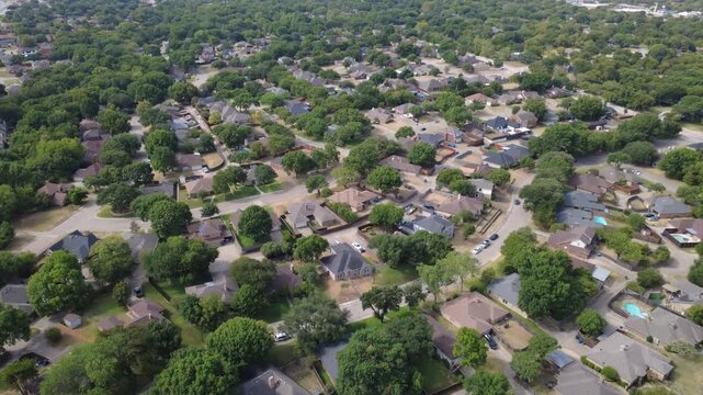Rolling residential subdivisions spread across Meadowbrook neighborhood near Pleasant Run Road. Clustered single family brick homes feature blue pools, leafy oak trees, DeSoto, Texas