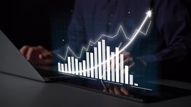 A professional analyzes business growth using a digital graph displayed on a laptop screen. The modern office setting highlights the importance of data-driven decisions. Copula