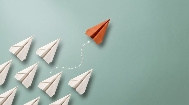 Agile business strategy and course correction concept featuring orange paper airplane turning away from group