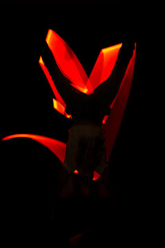 Abstract long exposure light painting showing a person doing a handstand