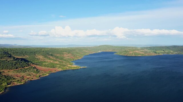 Wide panoramic aerial footage of Lac de Salagou in Herault, Occitanie, France.