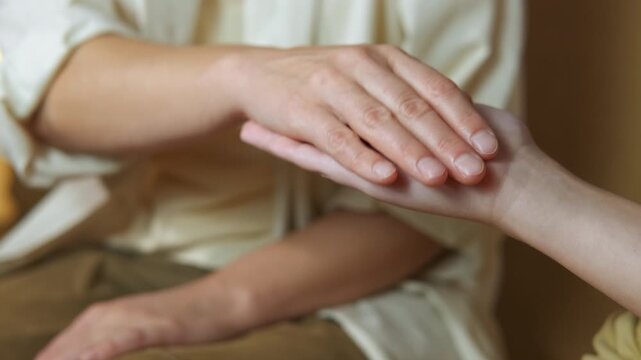 Reiki energy healing session hands transferring energy. Close-up of a reiki practitioner's hands performing an energy healing session by channeling ki energy to the patient's palm