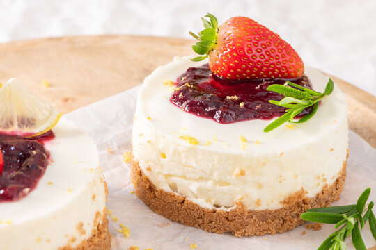 Mini berry cheesecakes topped with fresh strawberry