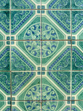 Traditional Portuguese green and blue ceramic tiles with intricate geometric patterns