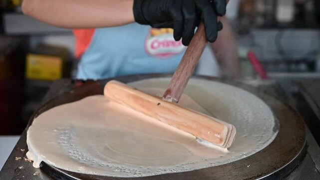 Chef making a french cr&ecirc;pe on a hot griddle