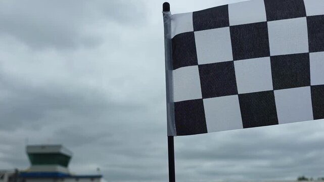 Flag signals the end of a race at a busy track