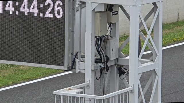 Timing gear by racetrack scoreboard
