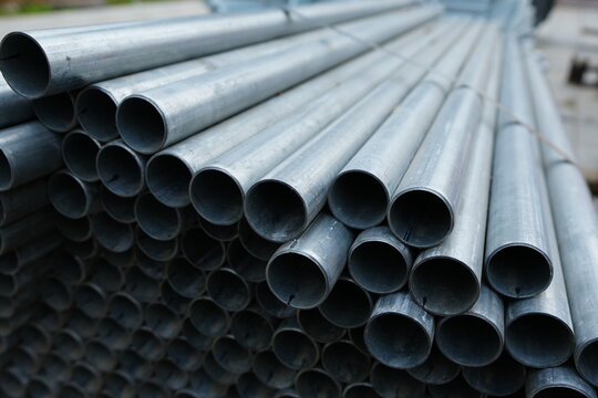 Stacked industrial metal pipes prepared for infrastructure and construction projects, representing engineering, utility systems, industrial materials and modern development