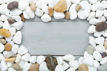 White pebble stones on wooden background, top view © Liami