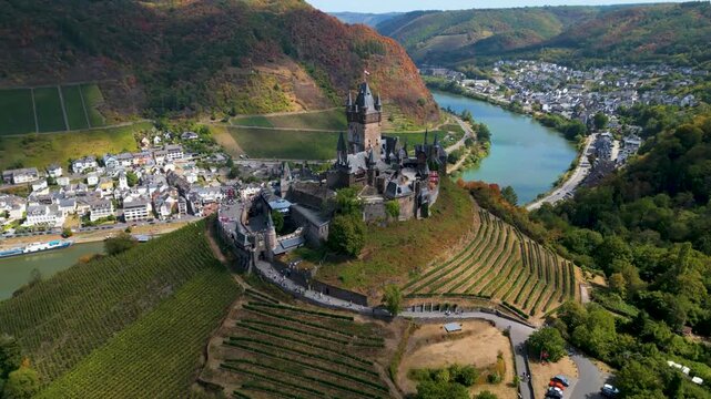 Right-to-left drone orbit around Cochem Castle above Moselle