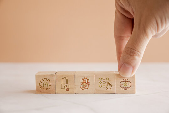 Hands holding wooden blocks with icons, cyber security, risk management, business concept
