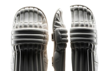 Fototapeta premium Three white cricket leg guards stand against a bright background. Padded protective gear used by batters and wicketkeepers. Sports equipment on plain white.