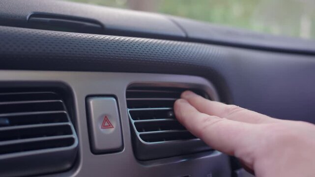 Hand Adjusting Car Air Vent on Dashboard Close Up | Person Directing Airflow from Interior Ventilation System | Automobile Climate Control Detail