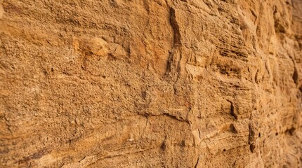 Fototapeta premium Close-up view of layered sandstone rock formation showing texture and striations.